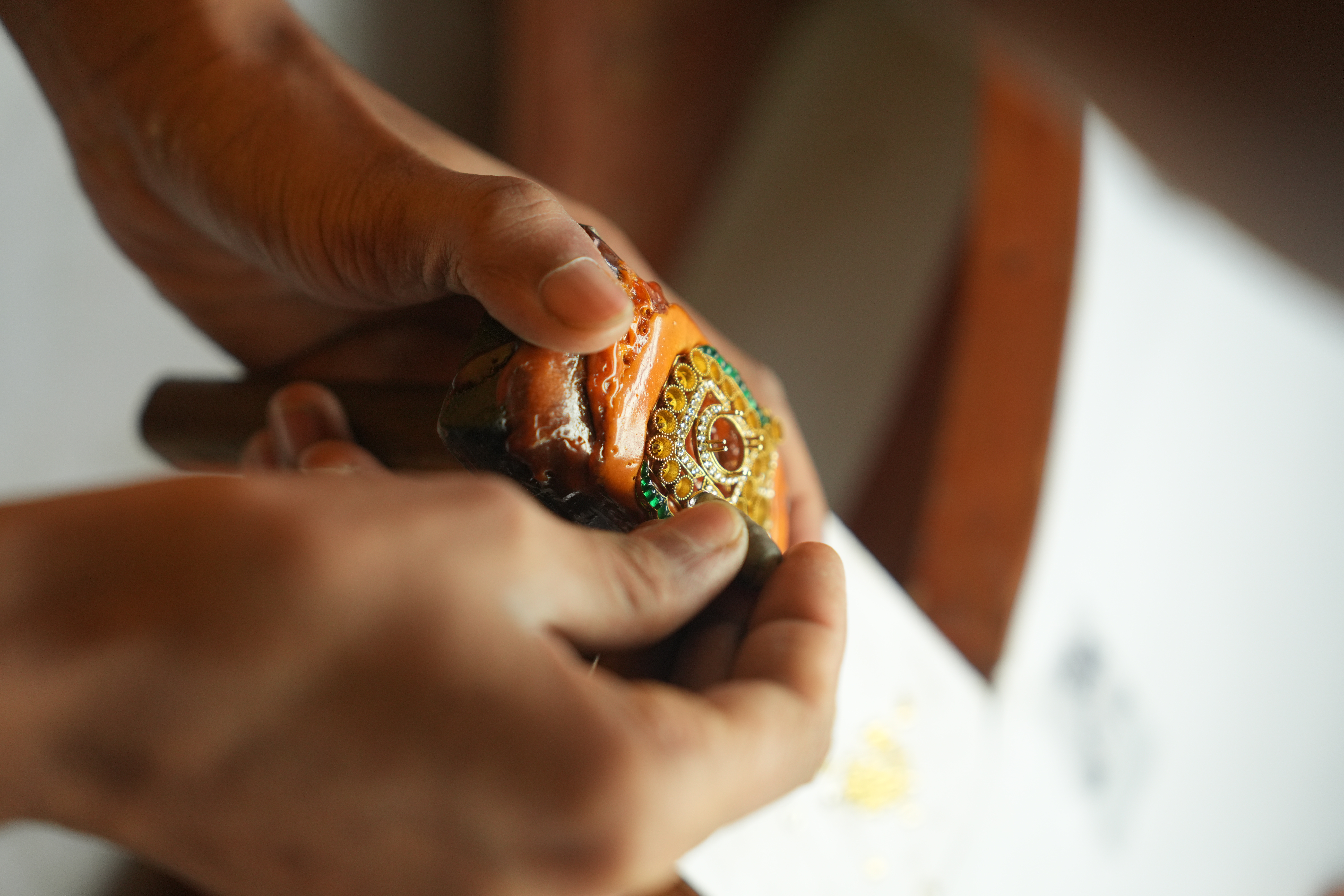 Artisan inspecting gemstone